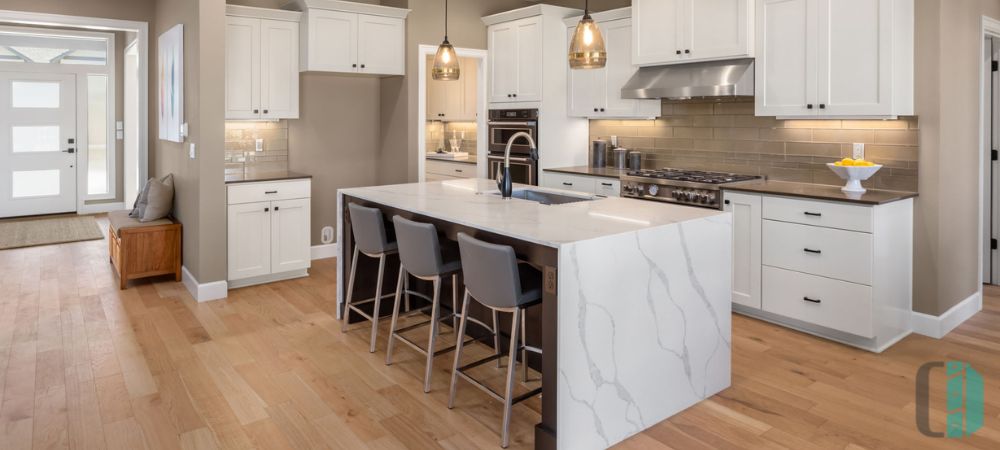 Modern kitchen cabinets with a sleek waterfall island countertop, providing a seamless and elegant focal point.