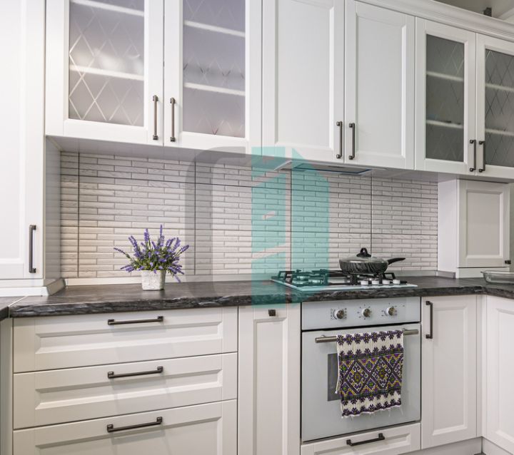 Kitchen cabinets with dark countertops, providing a sleek and modern look with dramatic contrast